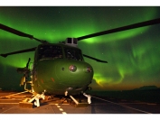 A Lynx Mk7 from 847 NAS on the deck of HMS Albion against the backdrop of the Northern Lights during EX JOINT WINTER 2004