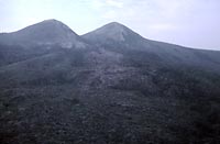 Figure A28. Volcano MountainVolcano Mountain is a small, asymmetrical cinder cone approximately 300 m high. Lava flows issued through breaks in the cone wall to the northeast and to the southwest. (Photograph by L. Jackson)