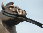 Muscular bronze stallion with weird human genitalia advertises provincial hotel