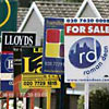 Boards advertising property for sale and rent are seen in east London