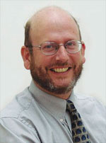 Christopher Buice, smiling in a formal headshot. Photo courtesy Tennessee Valley UU Church.