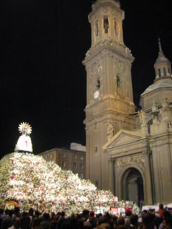 The Pilar Virgen surrounded by flowers in the Pilar Festival celebrations.