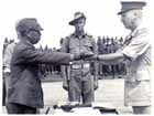 After signing the surrender documents, Lieutenant General ADACHI Hataz hands over his sword to the General Officer Commanding the 6th Division, Major General H. C. H. Robertson.