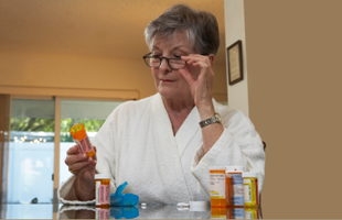 Woman reading prescription medicine label