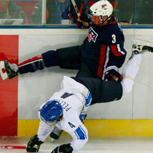 Courtney Kennedy of the United States and Heidi Pelttari of Finland collide during the women's ice hockey bronze medal match during the 2006 Winter Olympic Games in Turin, Italy.