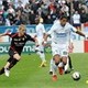 Marseille's foward Brandao (R) vies with Lens defender Yohan Demont (L)