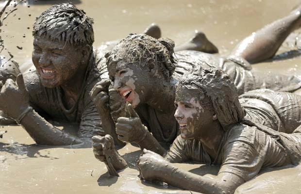 Children get some relief from the heat by playing in a gigantic lake of mud at the annual Mud Day event July 6, 2010 in Westland, Michigan.