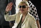 U.S. singer Madonna waves to fans as she arrives at Bandeirantes Palace to meet Sao Paulo's governor Jose Serra February 10, 2010.