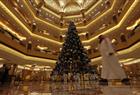 An Emirati man walks past an 11-million-dollar Christmas tree at the Emirates Palace hotel in the Emirati capital Abu Dhabi on December 15, 2010.