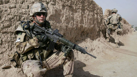 A Canadian soldier takes a position during a patrol in Arghandab, a district of Kandahar province, on July 6, 2008. About 2,500 Canadian soldiers are currently serving in Afghanistan.