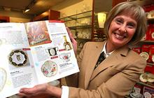 Janice Ilko with a catalogue showing the Royal Crown Darby Loving Cup and Five Petal tray commemorating Prince William and Kate. The Royal Doulton store at West Edmonton Mall is taking pre orders on the commemorative items.