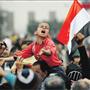 A boy chants anti-government slogans during demonstrations at Tahrir Square in Cairo on Monday, where protesters dug in for a long fight in their effort to force reforms to Egypt's political system.
