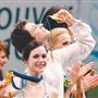 Canadians Tessa Virtue and Scott Moir receive their gold medals for ice dancing in Vancouver on Monday.