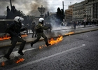 Riot police run towards demonstrators during clashes in front of the parliament in Athens on February 23, 2011. Greece is hit with another general strike against austerity as Prime Minister George Papandreou seeks to convince the cash-strapped country's eurozone partners to extend the repayment of a massive rescue loan.