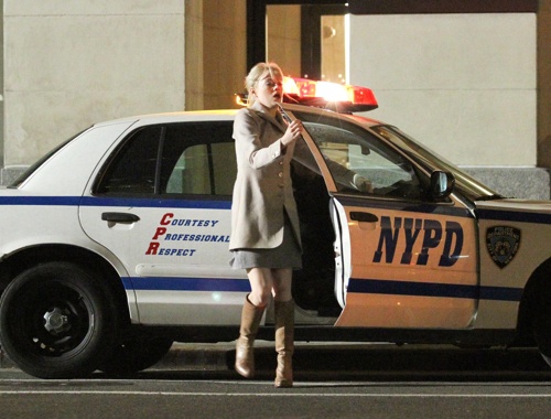 Emma Stone exists a NYPD Cruiser while filming 'The Amazing Spiderman' in Midtown Manhattan.