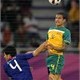 Japan's defender Yasuyuki Konno (L) challenges Australia's striker Tim Cahill