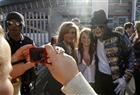 A Michael Jackson look-alike poses with fans as they queue for the " Michael Forever" tribute concert, which honours late pop icon Michael Jackson, at the Millennium Stadium in Cardiff, Wales October 8, 2011