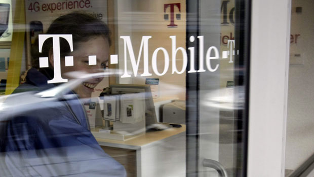A customer walks out of a T-Mobile store in Palo Alto, Calif.