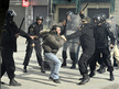 Police officers beat a demonstrator in the center of Tunis on January 17, 2011 (AFP Photo / Fred Dufour)