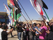 Demonstrators holding Kurdish and Syrian opposition flags gather during a protest against Syria's President Assad in Qamishli (REUTERS/Shaam News Network/Handout)