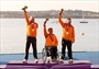 Udo Hessels, Marcel van de Veen and Mischa Rossen of Netherlands celebrate winning gold 
