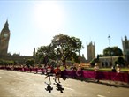 Competitors run past Big Ben in the men's marathon