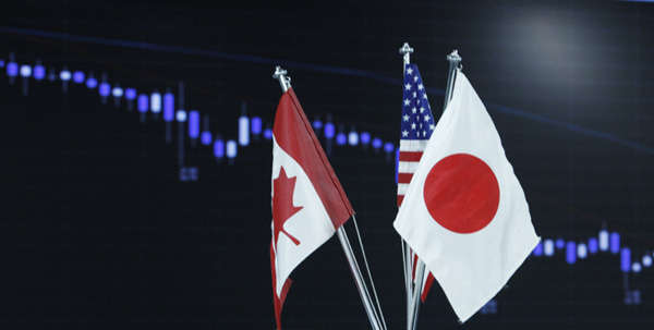 Country flags are seen in front of a graph displaying movements of the U.S. dollar and Japanese yen exchange rates at a dealing room in Tokyo October 8, 2010. Japan's cabinet agreed on Friday to compile an extra budget worth 5.05 trillion yen ($61.33 billion) to bolster an economy struggling with persistent deflation and a rising yen. REUTERS/Issei Kato