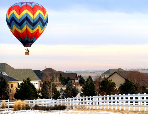 JIM RYDBOM/jrydbom@greeleytribune.com
A hot air balloon owned by Craig Fisher floats over rooftops in the Hilltop Estates subdivision in south Windsor last week. Fisher was taking flight lessons with Debbi Waltman and later took a solo flight. Fisher is a fireman with the Windsor-Severance Fire Rescue.