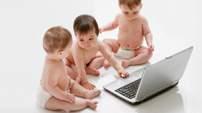 Babies playing with a computer