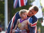 David Weir of Great Britain celebrates gold with his son