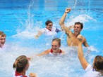 Tom Daley of Great Britain celebrates with his team mates after finishing third