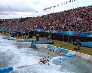 Spectators watch Tim Baille (front) and Etienne Stott compete in the men's Canoe Double (C2) Slalom