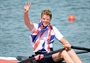 Alan Campbell of Great Britain celebrates in his boat with his bronze medal 