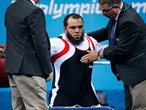 Mohamed Eldib of Egypt is helped by judges after securing gold
