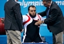 Mohamed Eldib of Egypt is helped by judges after securing gold