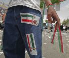 A man wears jeans with the stickers of President Mahmoud Ahmadinejad