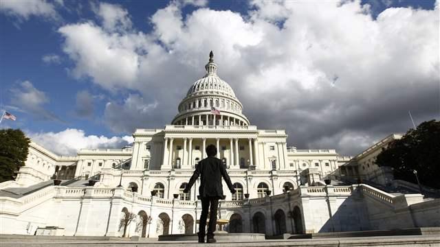 A tourist gazes up towards the dome of the U.S. Capitol in Washington (REUTERS/Kevin Lamarque).
