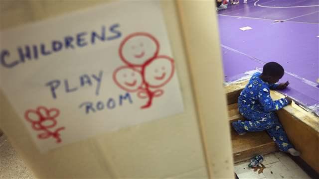 A young boy colors with crayons in the children's playroom at a Red Cross shelter in Hampton Bays, New York (REUTERS/Lucas Jackson).