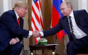 In this July 16, 2018, photo, U.S. President Donald Trump, left, and Russian President Vladimir Putin, right, shake hands at the beginning of a meeting at the Presidential Palace in Helsinki, Finland