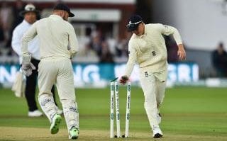 England's Ollie Pope (R) runs out India's Cheteshwar Pujara for 1 run on the second day of the second Test